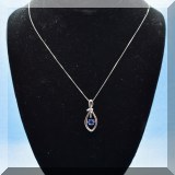 J05. Sterling silver knot pendant with sapphire on 18” sterling box chain. - $95 